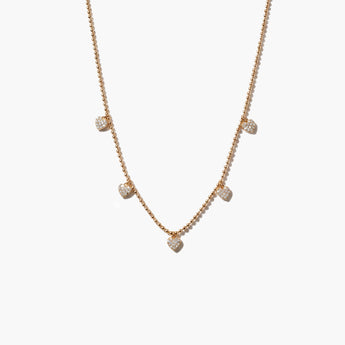 gold necklace with heart-shaped pendants on a white background